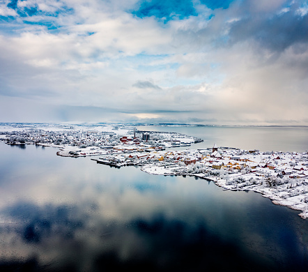 Drone’s eye view of the medieval town of Stege on the island of Moen in Denmark, covered in snow, photographed late November 2022. Colour, vertical format with lots of copy space. Stege’s history can be traced back to medieval times when it was an important part of the herring trade and a staging post for the Hanseatic League