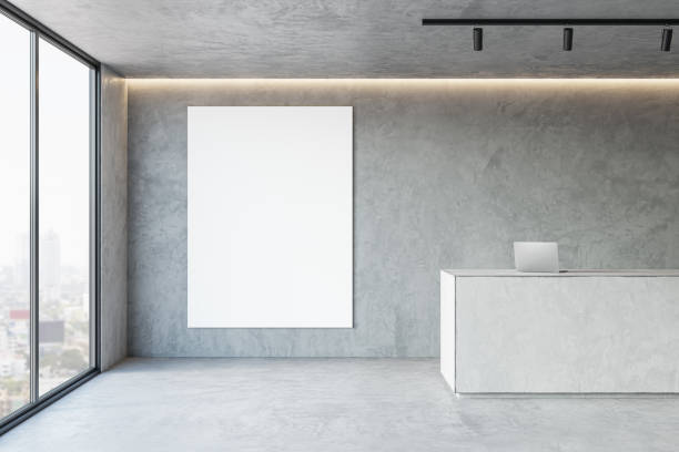 istock Front view on blank white poster on grey wall background with place for your logo or text in spacious hall with concrete reception desk and city view from panoramic window. 3D rendering, mockup 1449313412