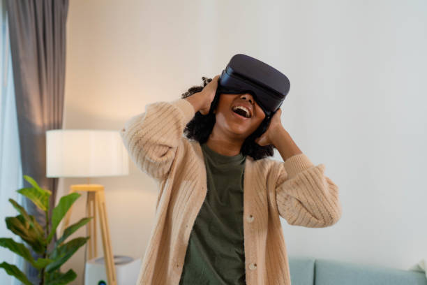 istock Sibling having fun with virtual reality glasses at home. 1449315579
