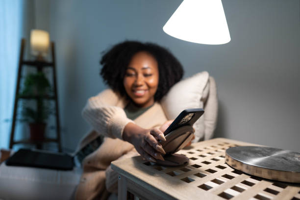 istock Woman putting her smartphone on wireless charger 1449315630