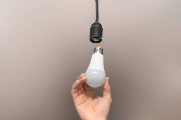 istock LED lamp in the man's hand. 1449316208