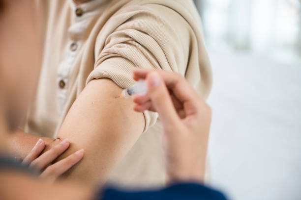 istock Asian elderly old man getting coronavirus vaccine with nurse 1449317311
