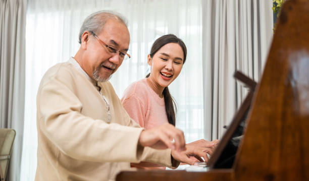 istock Young woman teaching piano for senior man teaching 1449317326
