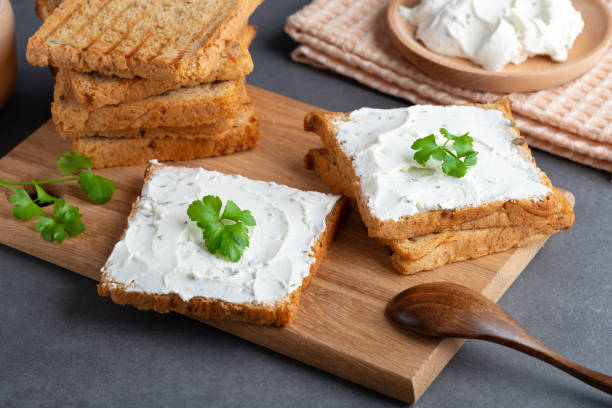 istock Bread with cream cheese on grey table. Whole grain  bread with seeds 1449318087