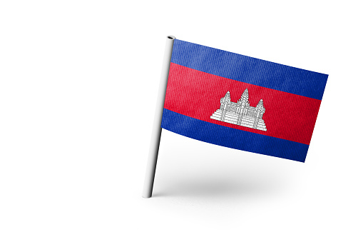 Small paper flag of Cambodia pinned. Isolated on white background. Horizontal orientation. Close up photography. Copy space.