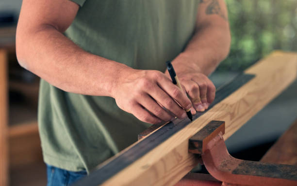 istock Man carpenter, measure wood for building and construction project for professional home renovation. Handyman, measuring wooden beam and marking measurements with pen for creating decoration for house 1449319531