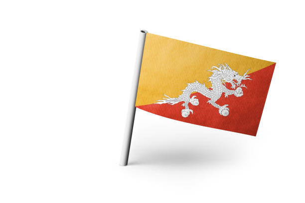 Small paper flag of Bhutan pinned. Isolated on white background. Horizontal orientation. Close up photography. Copy space.
