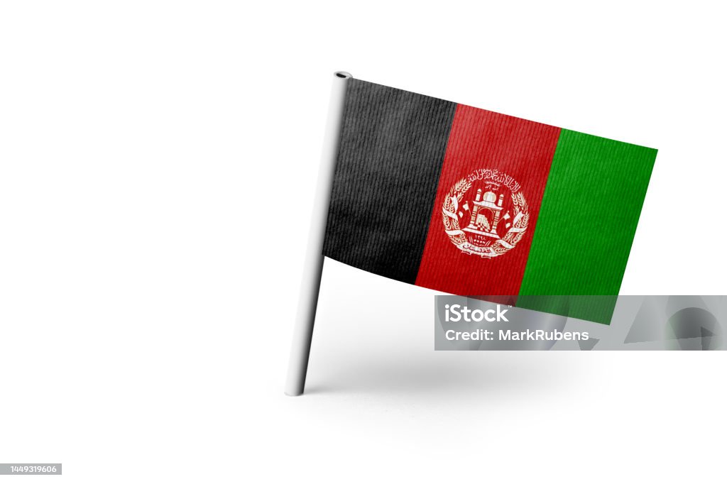 Afghan flag pinned. White background. Small paper flag of Afghanistan pinned. Isolated on white background. Horizontal orientation. Close up photography. Copy space. Afghan Flag Stock Photo