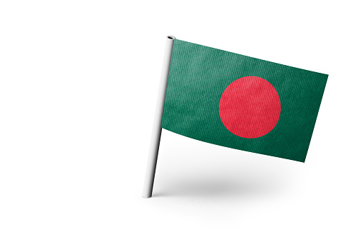 Small paper flag of Bangladesh pinned. Isolated on white background. Horizontal orientation. Close up photography. Copy space.