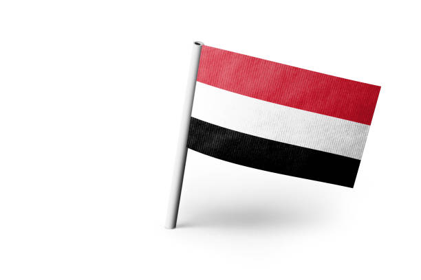 Small paper flag of Yemen pinned. Isolated on white background. Horizontal orientation. Close up photography. Copy space.