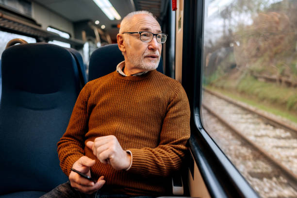 istock Senior man enjoying a view while riding in a train 1449321159
