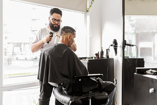 Hairdresser working in barber shop