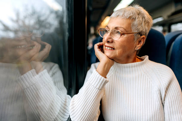 istock Senior woman enjoying a view while riding in a train 1449321996