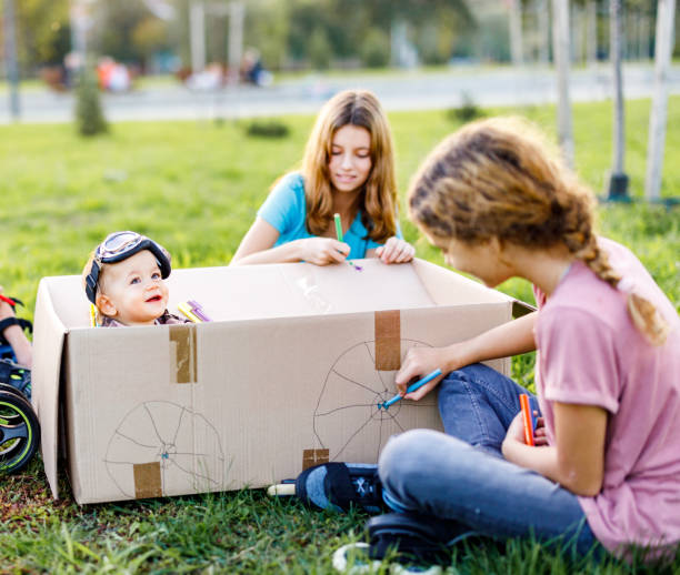 istock Children playing whit cardboard box in the nature 1449324727