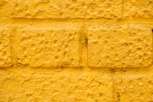 istock Close view of yellow wall of bricks. 1449325030