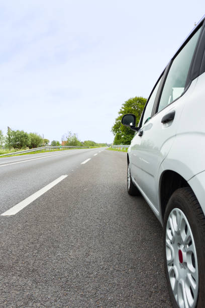 istock Rear ride view of a generic light color car 1449325084