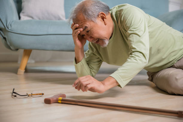 istock Sick senior old man falling down lying on the ground because stumbled at home 1449325301