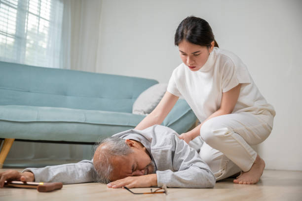 istock Asia young woman halping her father after falling down on floor 1449325336