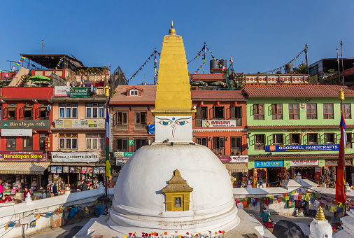 Stupa in front of colorful buildings at the Boudhanath stupa in Kathmandu, Nepal