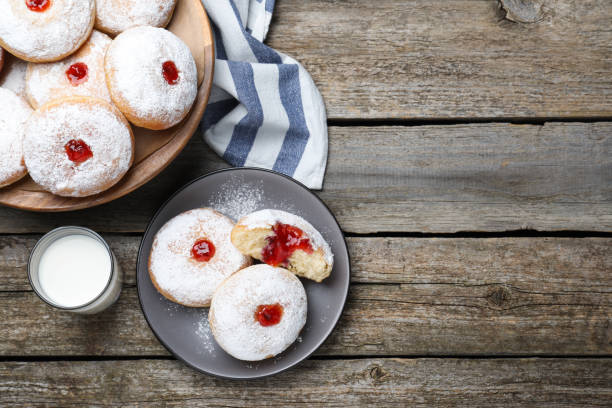 istock Delicious jelly donuts served with milk on wooden table, flat lay. Space for text 1449327982