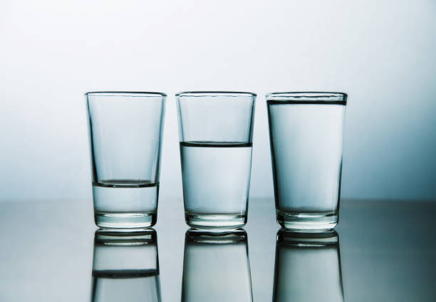 istock three water glasses each one have more water than the other 1449330261