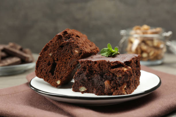 istock Delicious brownies with nuts and mint on table, closeup 1449331412