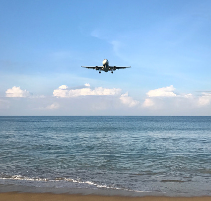 An airplane coming in for landing at the airport in Phuket, Thailand.