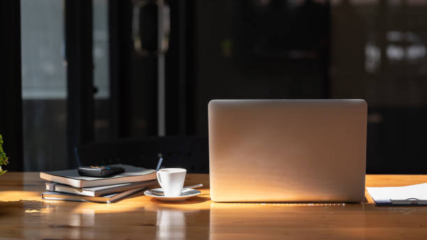istock Front view of the laptop and the working devices placed on the table at the office. 1449332989
