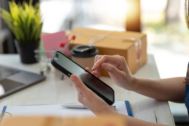 istock Woman using mobile phone to send text , work or play social media. 1449333021