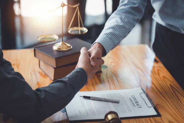 Businessman shaking hands partner lawyers or attorneys discussing a contract agreement. stock photo