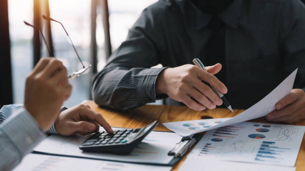 istock Businessman discuss investment project working and planning strategy and using calculator during a business meeting. 1449333486
