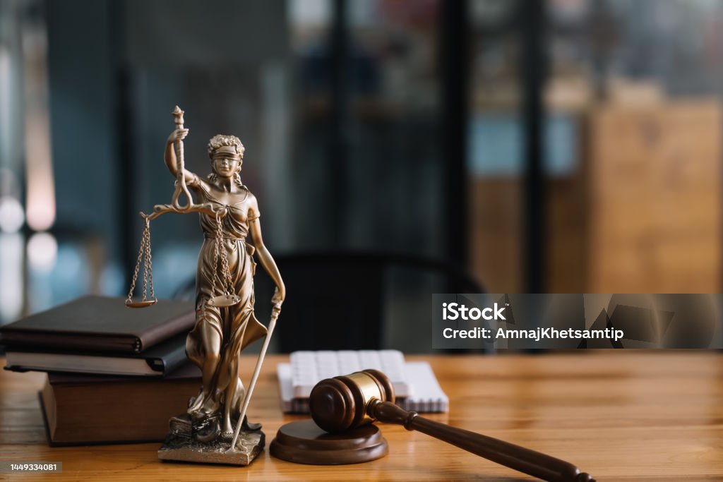 Statue of lady justice on desk of a judge or lawyer. Law Stock Photo