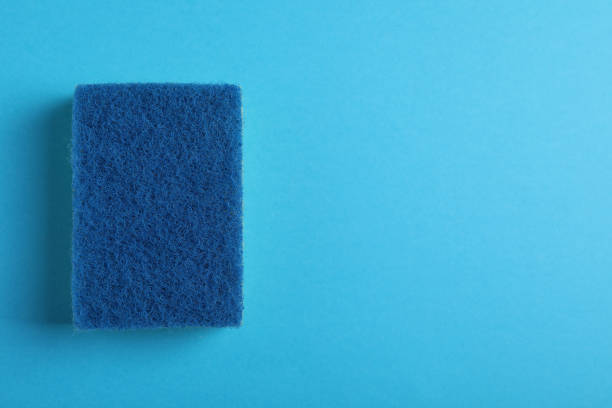 istock New sponge on light blue background, top view. Space for text 1449334728