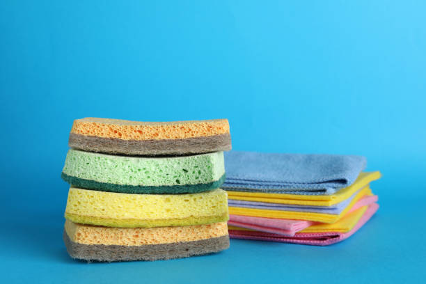 istock Color sponges and rags on light blue background 1449335673