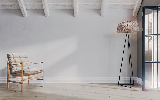 Empty Scandinavian-style attic semi-furnished room with a retro chair and electric lamp in front of a white plaster weathered wall background with copy space on the hardwood floor. Ceiling with white weathered old roof beams in good sight and an open large retro window on a side.  A slight vintage effect was added. 3D rendered image.
