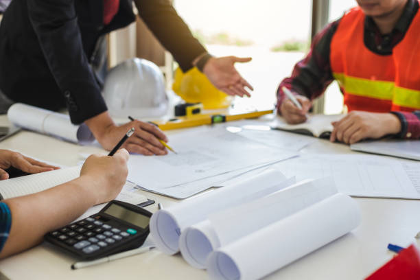 istock Teamwork process, Engineer and businessman meeting and planning construction project together. 1449339030