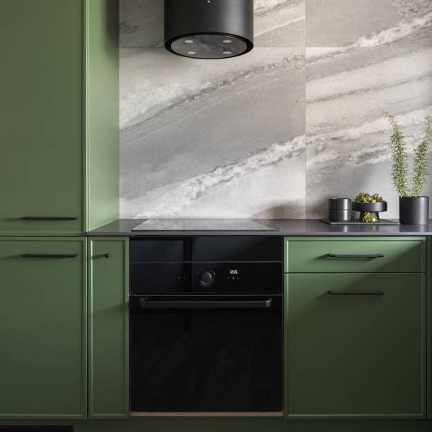 istock Black oven in trendy green kitchen 1449340201