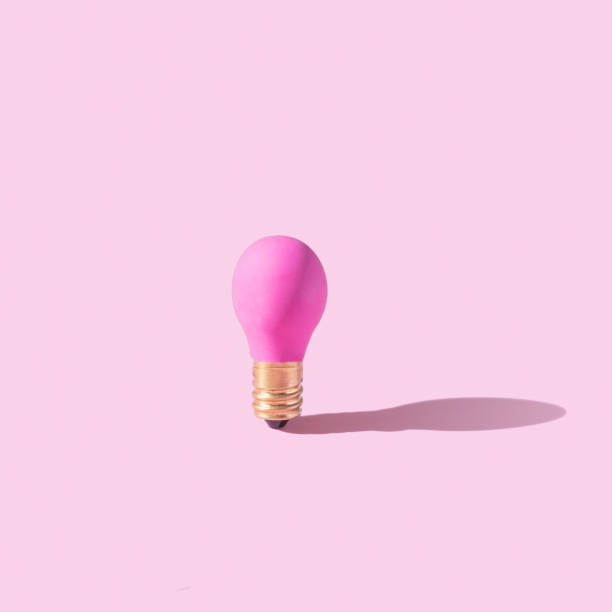 istock Pink lamp on pink background. Creative idea or startup concept. Monochrome 1449341532