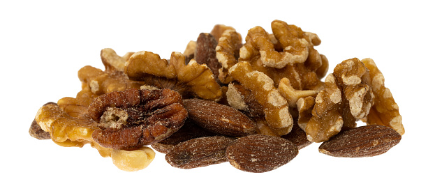 Portion of assorted nuts isolated on a white background side view.