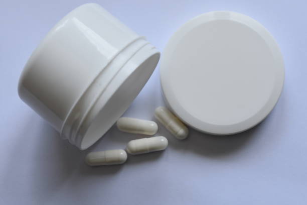 istock White pills and package box on a white background stock photo 1449344761