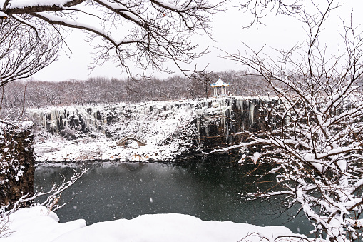 The pool under Diaoshuilou Waterfall will never froze due to underground volcanic heat, while the waterfall itself is always frozen in winter. The waterfall is a part of Jingpo Lake in Heilongjiang province, China.