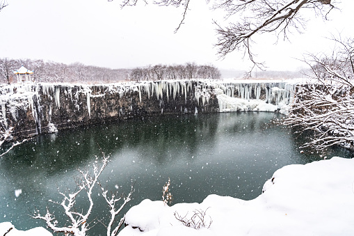 The pool under Diaoshuilou Waterfall will never froze due to underground volcanic heat, while the waterfall itself is always frozen in winter. The waterfall is a part of Jingpo Lake in Heilongjiang province, China.