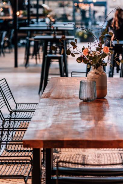 istock Vertical shot of an empty restaurant table with a flower vase 1449346730
