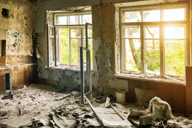 istock An abandoned Soviet military barracks in a military unit. Empty grunge abandoned ruined room with shabby walls and sunlight from large windows. Grungy warehouse basement background. Copy text space 1449347132