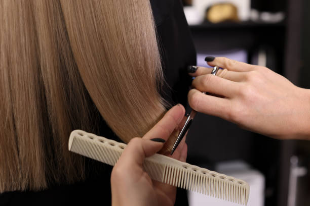 istock Professional hairdresser cutting woman's hair in salon, closeup 1449347310