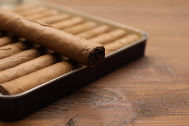 istock Many cigars in box on wooden table, closeup 1449347369