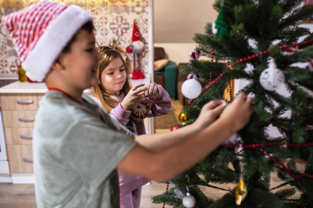 istock Happy decorating the Christmas tree 1449350442