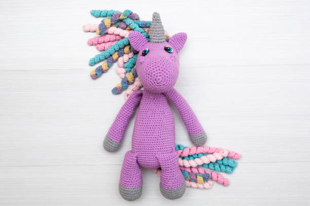 istock A knitted unicorn with a multicolored mane. A toy for a child. 1449351104