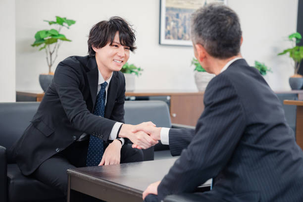 istock Businessmen shaking hands at a B2B business meeting 1449351262