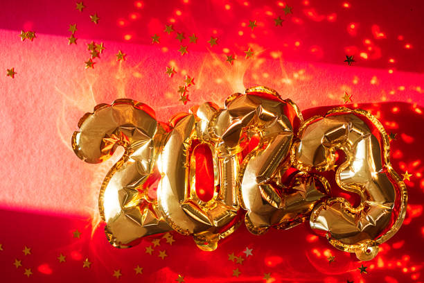 istock 2023 shine foil balloons. New year sparkling background. 1449351528